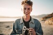 Close-up portrait photography of a grinning boy in his 20s holding a wrench wearing a chic cardigan at the dead sea in israel/jordan. With generative AI technology