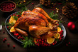 Traditional delicious Christmas turkey on a wooden xmas decorated table close up