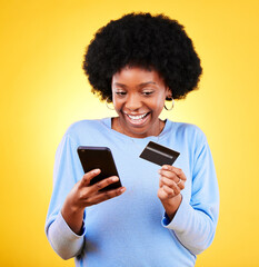 Wall Mural - Happy black woman, phone and credit card in online shopping against a yellow studio background. Excited African female person with afro smile on mobile smartphone app in ecommerce, payment or banking