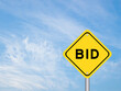 © bankrx - Yellow transportation sign with word bid on blue color sky background