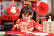 young girl with traditional dressing up celebrating Chinese new year against all kind of 