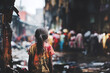 View from behind a young lonely homeless girl standing outside in a dirty slum
