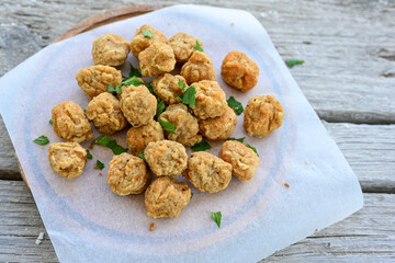 Wall Mural - Crispy  deep fried   chicken  nuggets . Breaded  with Cornflakes Breast fillets  with chilly peppers and fresh   basil on wooden rustic background