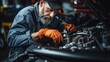 auto mechanic repairing car engine in auto repair shop.