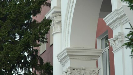 Wall Mural - Establishing shot of part of white arch and column, classic style building exterior on summer dayEstablishing shot of part of white arch and column, classic style building exterior on summer day