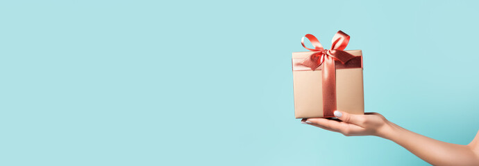 a woman holds a gift box with cosmetics on a blue background