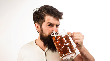 Wall Mural - Bearded man drinking fresh brewed beer in pub or bar. Celebration oktoberfest festival. Man tasting draft craft beer. Lager or dark beer. Alcohol. Beer degustation. Germany tradition. Brewery concept.