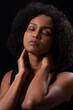 © ADDICTIVE STOCK - Ethnic woman touching neck with closed eyes in studio