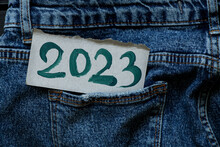 2023 Is Written In Green Paints On A Paper Card That Lies In A Jeans Pocket, Happy New Year 2023, Banner