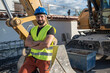 © Antonio Recena - construction worker near to backhoe rear view