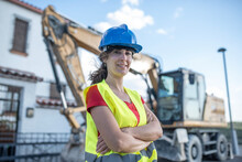 Female Construction Worker Near To Backhoe