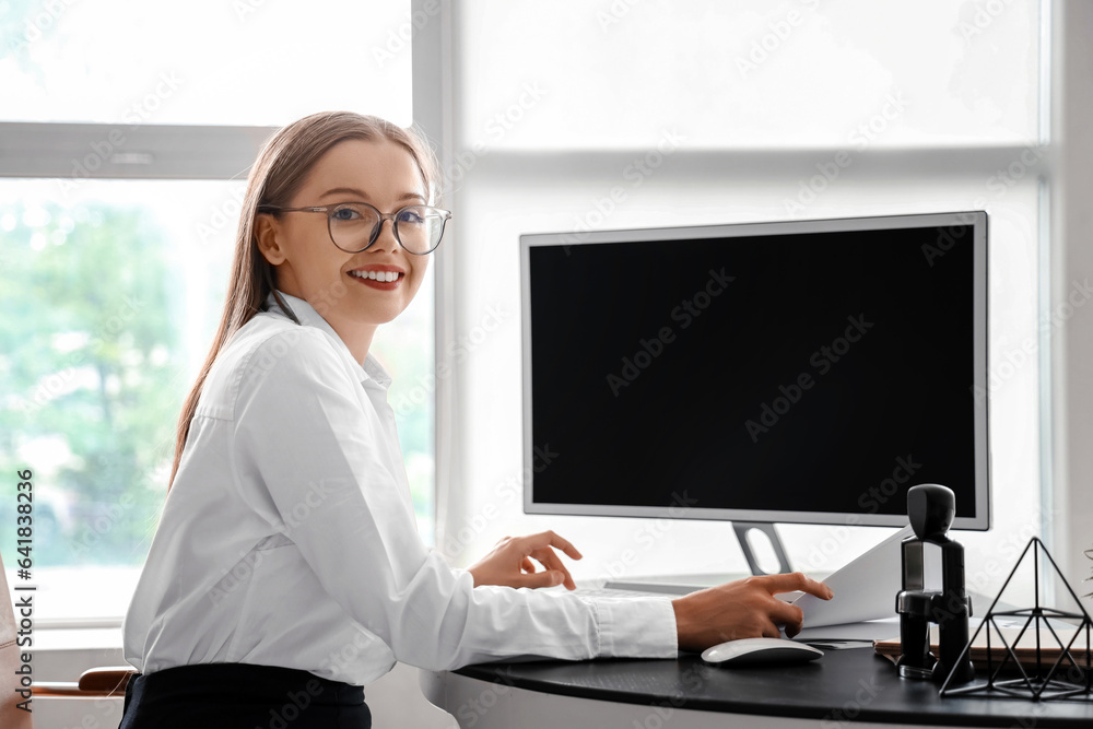 Young businesswoman working with computer in office