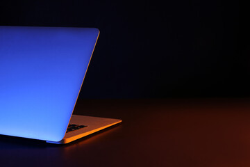 Modern laptop on black background