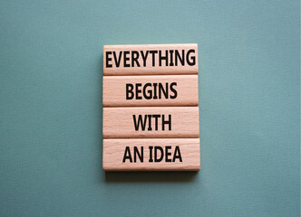 Everything begins with and Idea symbol. Concept words Everything begins with and Idea on wooden blocks. Beautiful grey green background. Business. Copy space.