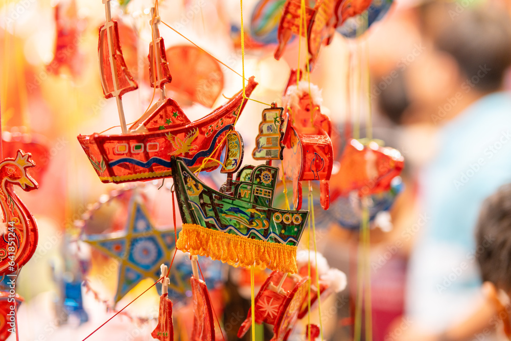 Decorated colorful lanterns hanging on a stand in the streets in Ho Chi ...