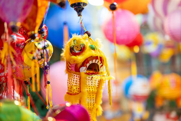 Wall Mural - Decorated colorful lanterns hanging on a stand in the streets in Ho Chi Minh City, Vietnam during Mid Autumn Festival. Chinese language in photos mean money and happiness