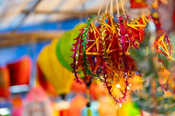 Wall Mural - Decorated colorful lanterns hanging on a stand in the streets in Ho Chi Minh City, Vietnam during Mid Autumn Festival. Chinese language in photos mean money and happiness