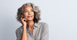 Leinwandbild Motiv Black adult woman touch face with smooth healthy skin. Beautiful aging mature woman with long gray hair and happy shy smiling. Beauty and cosmetics skincare advertising concept.