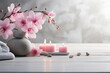© Jminka - Spa stones, pink flowers and candles on white table.
