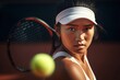 © Justlight - A tight closeup of a Eurasian female tennis player with a blurred tennis court in the background.