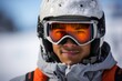© Justlight - A focused Latin American male skier posed in a standstill closeup portrait against a partially blurred winter background.