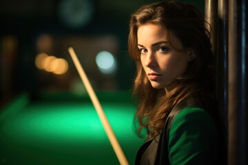 Caucasian female snooker player with her cue out in front of her looking thoughtfully at the camera against a vague snooker background.