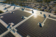 Aerial view of blue photovoltaic solar panels mounted on shopping mall building roof for producing green ecological electricity. Production of sustainable energy concept