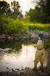Boy fishing for trout in a Montana river