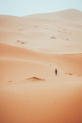 Wall Mural - Incidental local berber man wandering through Sahara Desert Merzouga, Morocco