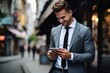 © The Little Hut - Generative AI : A young man businessman walks down the street in a suit and reads messages, news on the phone. He looks at the screen with a smile, calls, chats.