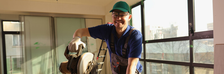 Carpenter working using electrical equipment for cutting board