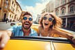 © ttonaorh - Happy young couple driving a convertible car on a city street. Summer vacation and travel concept