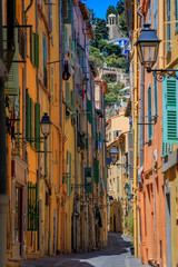 Wall Mural - Picturesque narrow streets with colorful traditional houses in the old town of Menton, French Riviera, South of France