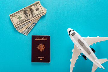 Wall Mural - World travel and tourist vacation booking concept, dollar bills french passport and airplane model