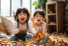 Happy Two Asian Children Playing With Blocks. Cute Little Children Playing While Sitting At Home