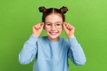 Canvas Print - Portrait of funny small girl try on eyesight specs eyeglasses oculist examination checkup isolated green color background