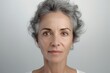 Close up pensive tired mature female face with wrinkles. Age, healthcare, beauty care concept