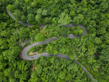 Fototapeta Uliczki - Aerial view road in the middle forest, Top view road going through green forest adventure, Ecosystem ecology healthy environment road trip travel net zero