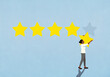 © fStop - Woman removing rating star from blue background
