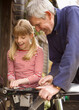 © fStop - Young girl helping grandfather repairing motorbike