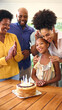 © Monkey Business - Multi-Generation Family Celebrating Granddaughter's Birthday With Cake And Candles At Home