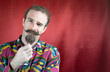 © CarlosMSubirats - Hipster man with mustache and handsome stroking his chin smug looking at camera