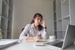 © wichayada - Businesswoman is stressed and tired from working all day at the office.