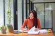 © Wasana - Portrait of smart business woman sitting with her busy work, calculate accounts, check statistics