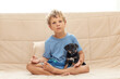 A boy with a little dog doing yoga