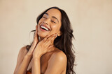 Fototapeta Miasto - Beautiful laughing woman touching her skin with joy