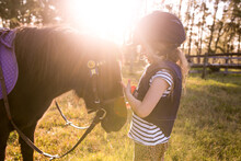 Young Girl With Horse In Late Afternoon