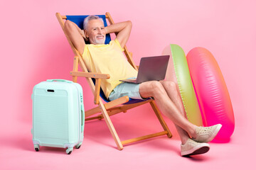 Sticker - Full body photo nap sleepy senior man hands head lying sunbed comfort watching netbook business course isolated on pink color background