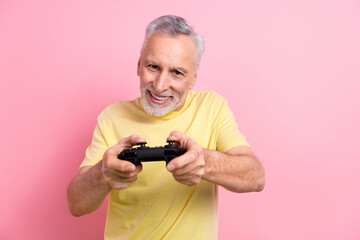 Poster - Portrait of toothy beaming person wear stylish t-shirt fingers hold playstation joystick play game isolated on pink color background