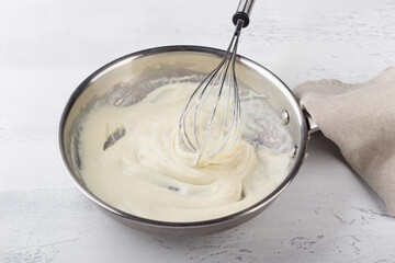 Wall Mural - Making cheese sauce for pasta. Add milk and mix until creamy. DIY step by step step 6